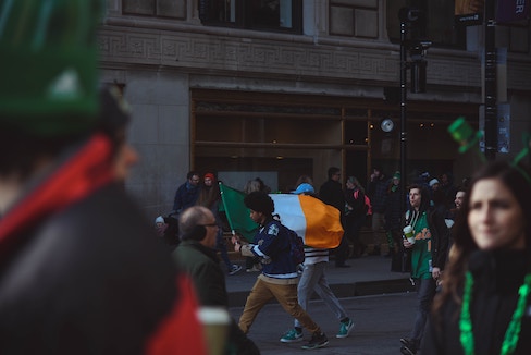 person carrying irish flag