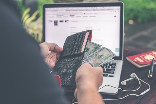 person checking cash before applying for loan