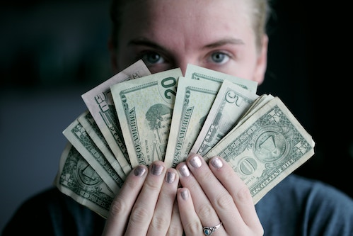 person holding wages in cash