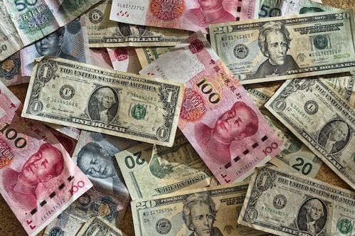 USD cash on table with Yuan