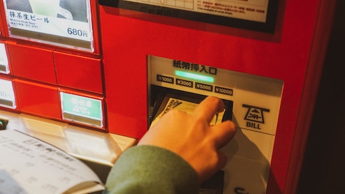 person picking up cash