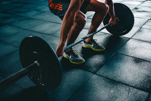 person poised to dead lift